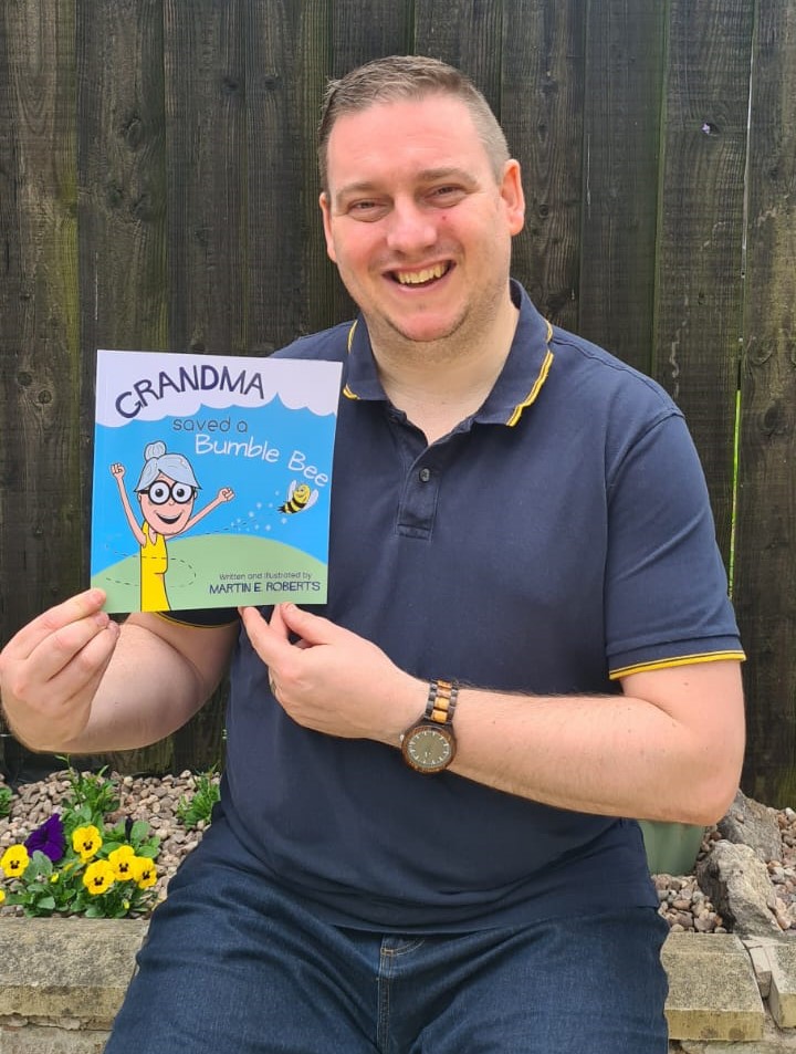 An image of the author/illustrator Martin E. Roberts holding his debut book with pride and a smile.